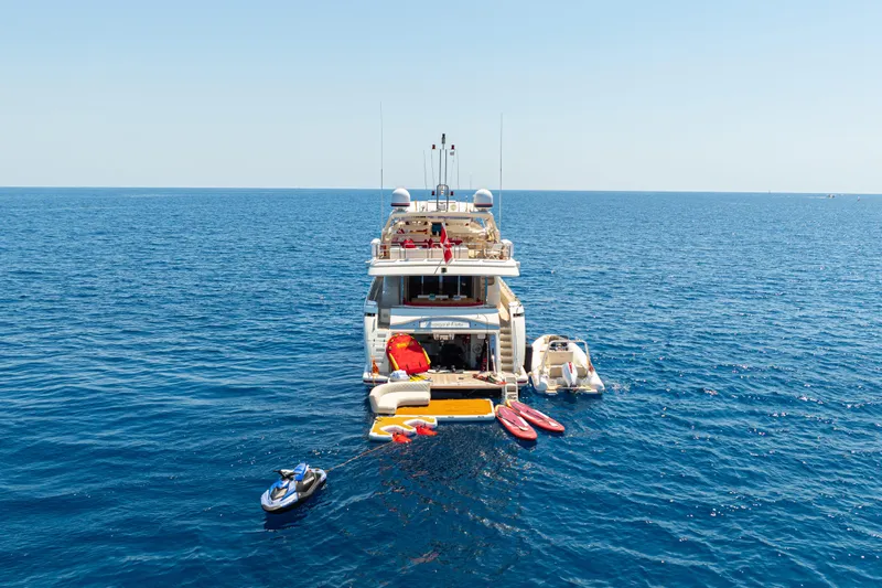 Champagne And Caviar Yacht Photos Pics Luxury Ferretti Yachts Custom Line 112, 2003 model, anchored with water sports equipment.