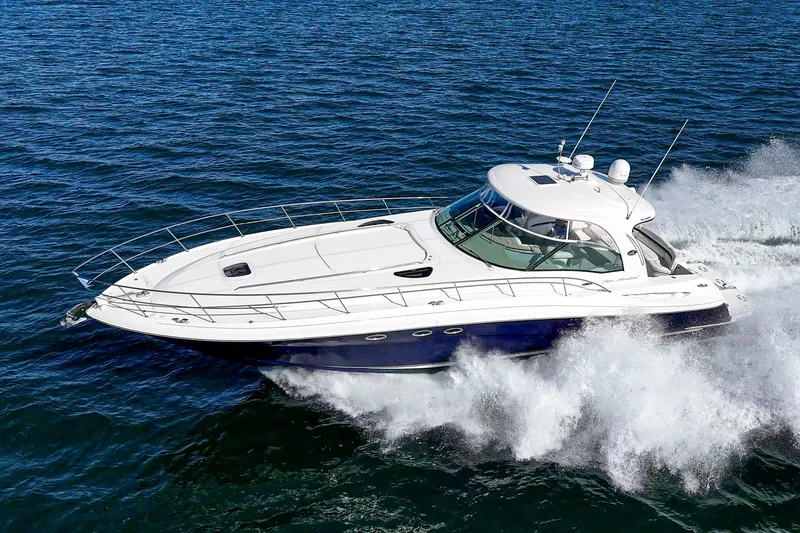 Enough 4 Now! Yacht Photos Pics 2005 Sea Ray 500 Sundancer cruising on open water, showcasing sleek design and powerful performance.