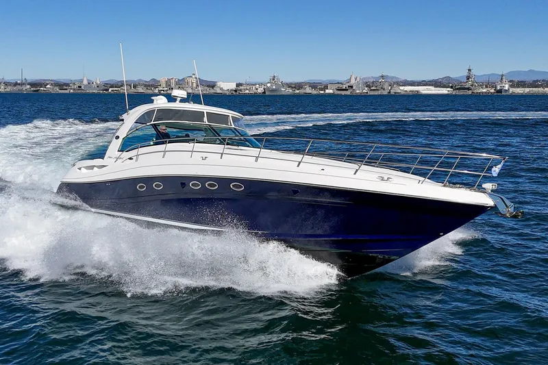 Enough 4 Now! Yacht Photos Pics 2005 Sea Ray 500 Sundancer cruising on open water, showcasing sleek design and powerful performance.