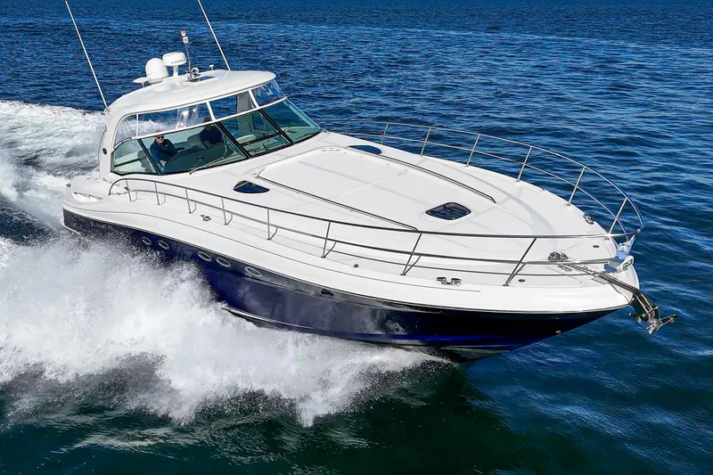 Enough 4 Now! Yacht Photos Pics 2005 Sea Ray 500 Sundancer cruising on open water, showcasing sleek design and powerful performance.