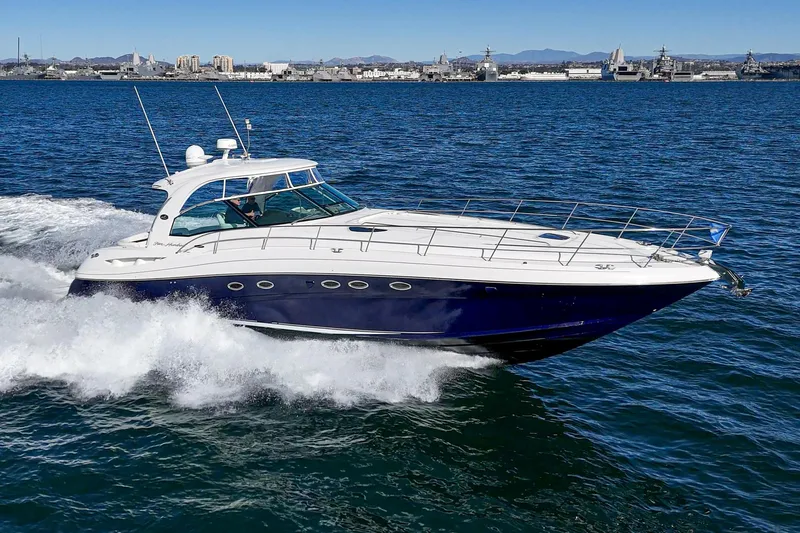 Enough 4 Now! Yacht Photos Pics 2005 Sea Ray 500 Sundancer cruising on open water, showcasing sleek design and powerful performance.