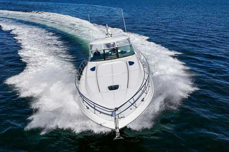 Enough 4 Now! Yacht Photos Pics 2005 Sea Ray 500 Sundancer cruising on open water, creating a dynamic wake.