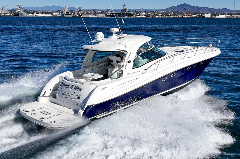 Enough 4 Now! Yacht Photos Pics 2005 Sea Ray 500 Sundancer cruising on open water, showcasing sleek design and powerful performance.