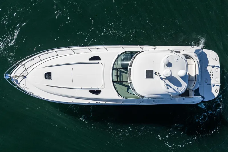 Enough 4 Now! Yacht Photos Pics Top view of a 2005 Sea Ray 500 Sundancer yacht cruising on water.