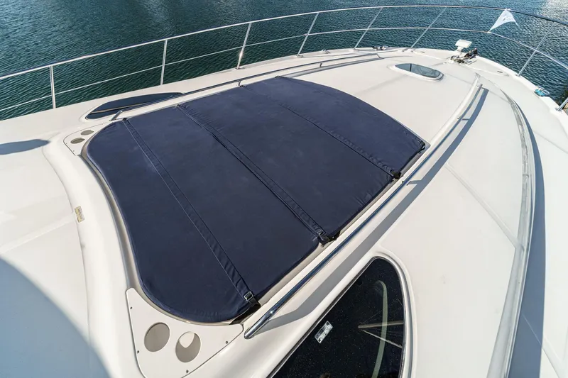 Enough 4 Now! Yacht Photos Pics 2005 Sea Ray 500 Sundancer yacht deck with sunpad, overlooking calm water.