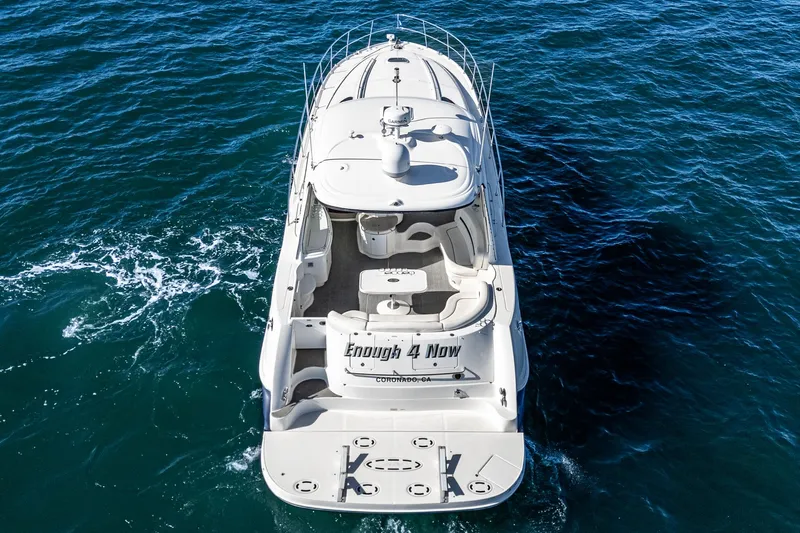 Enough 4 Now! Yacht Photos Pics 2005 Sea Ray 500 Sundancer yacht cruising on open water, aerial view.