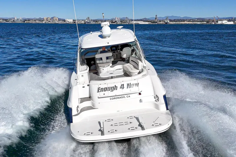 Enough 4 Now! Yacht Photos Pics 2005 Sea Ray 500 Sundancer cruising on open water, rear view.