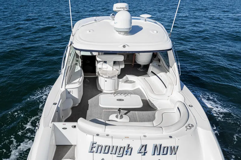 Enough 4 Now! Yacht Photos Pics 2005 Sea Ray 500 Sundancer yacht cruising on open water, rear view.