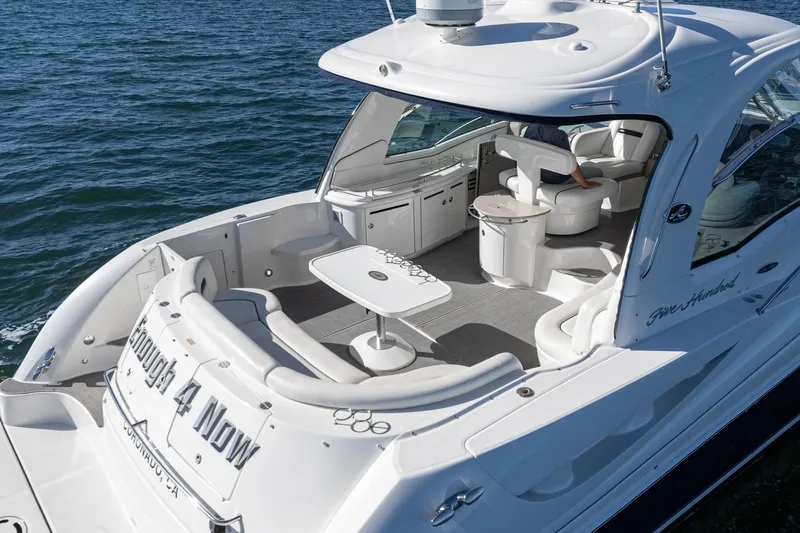 Enough 4 Now! Yacht Photos Pics 2005 Sea Ray 500 Sundancer yacht with spacious deck and seating on the water.