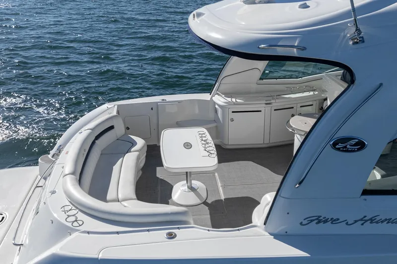 Enough 4 Now! Yacht Photos Pics 2005 Sea Ray 500 Sundancer yacht with spacious deck seating and table on open water.