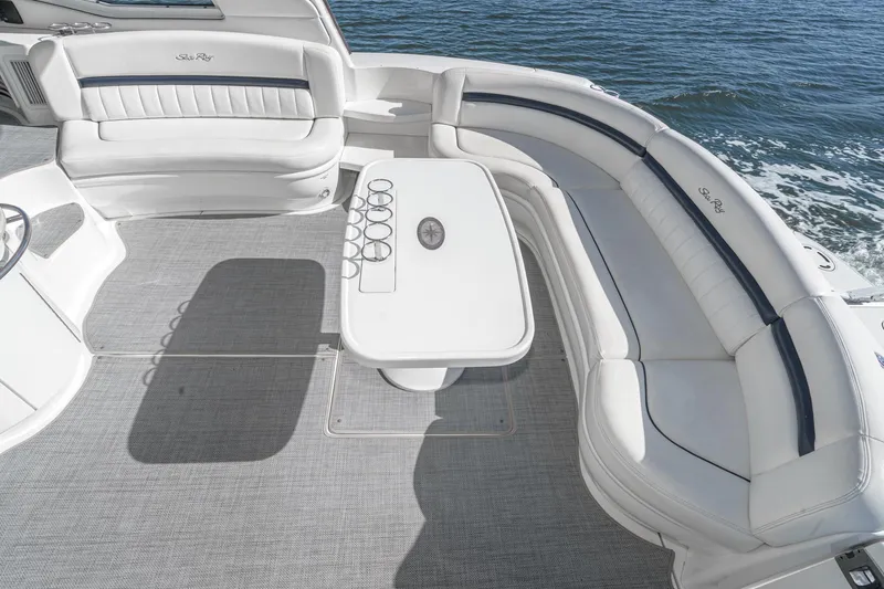 Enough 4 Now! Yacht Photos Pics Luxurious 2005 Sea Ray 500 Sundancer yacht deck with elegant seating and table, overlooking the ocean.