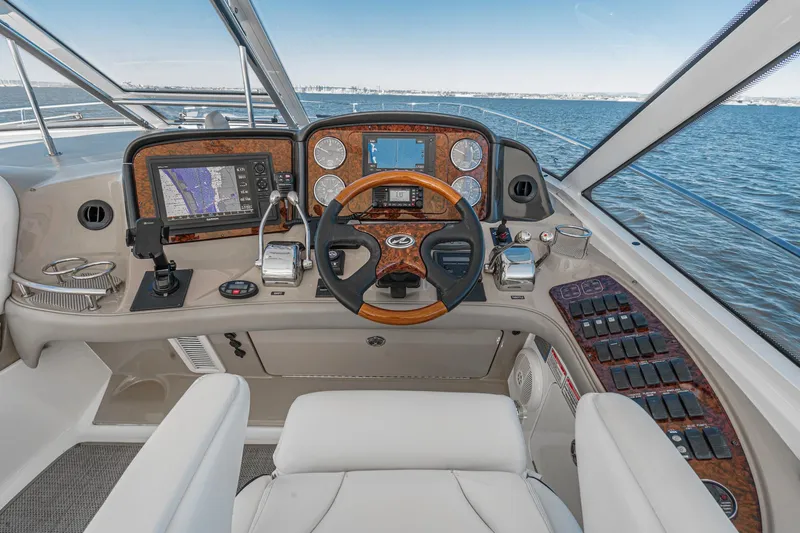 Enough 4 Now! Yacht Photos Pics Helm of 2005 Sea Ray 500 Sundancer yacht with navigation instruments and steering wheel.