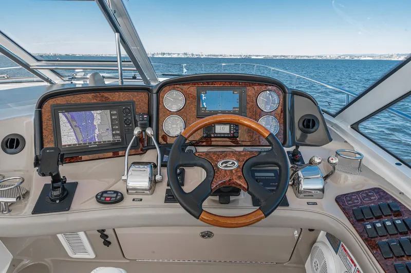 Enough 4 Now! Yacht Photos Pics 2005 Sea Ray 500 Sundancer helm with navigation controls and ocean view.