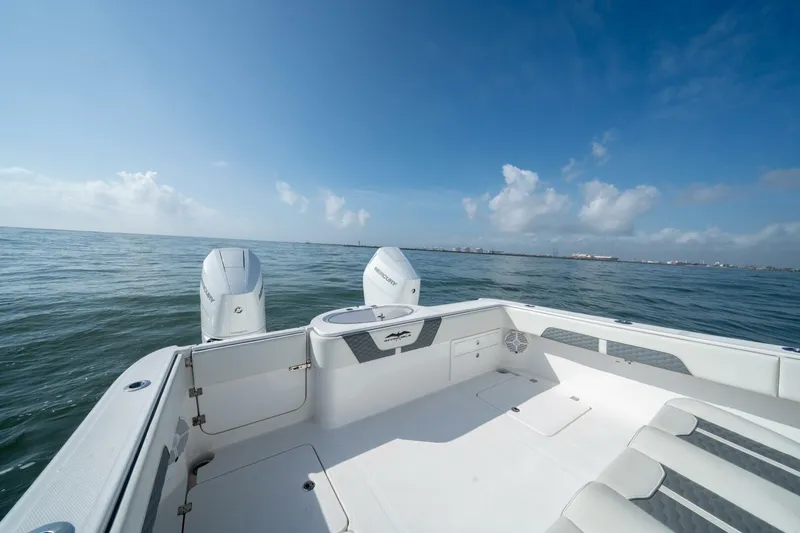 Kuhl Breeze Yacht Photos Pics 2024 Invincible 33 Catamaran on open water, showcasing spacious deck and twin engines.