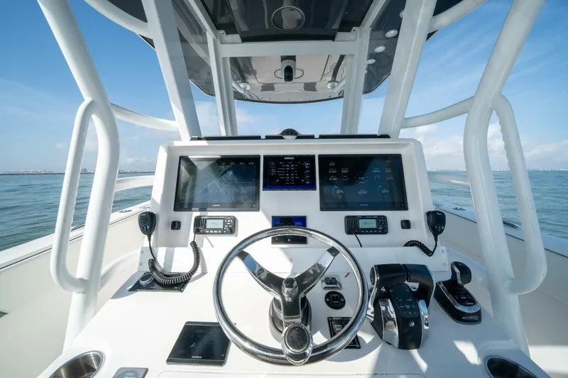 Kuhl Breeze Yacht Photos Pics 2024 Invincible 33 Catamaran helm with advanced navigation displays and controls on open water.