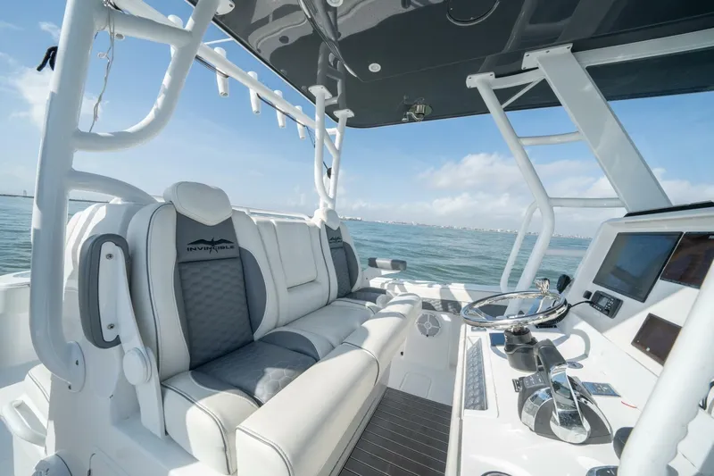 Kuhl Breeze Yacht Photos Pics 2024 Invincible 33 Catamaran interior with modern helm and seating, ocean view.