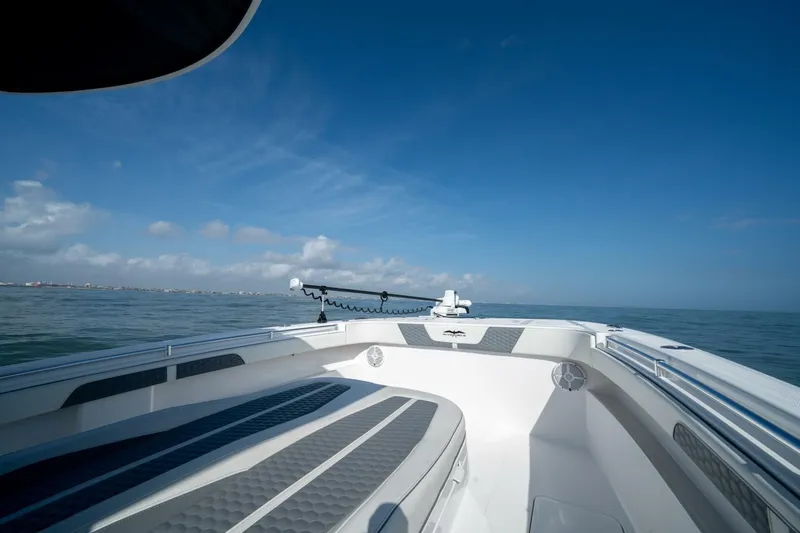Kuhl Breeze Yacht Photos Pics 2024 Invincible 33 Catamaran on open water under clear blue sky.