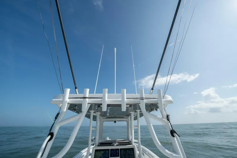 Kuhl Breeze Yacht Photos Pics 2024 Invincible 33 Catamaran on open sea under clear blue sky.