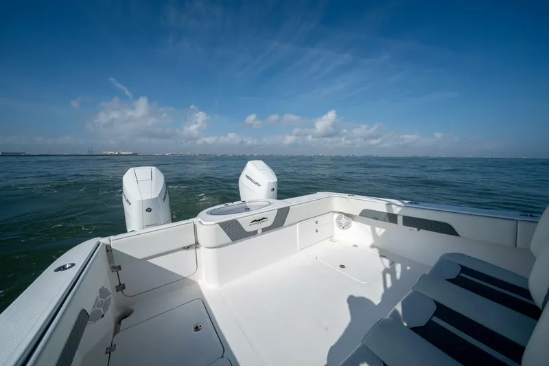 Kuhl Breeze Yacht Photos Pics 2024 Invincible 33 Catamaran on open water, featuring dual Mercury engines.