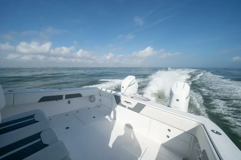 Kuhl Breeze Yacht Photos Pics 2024 Invincible 33 Catamaran cruising on open water under clear blue skies.