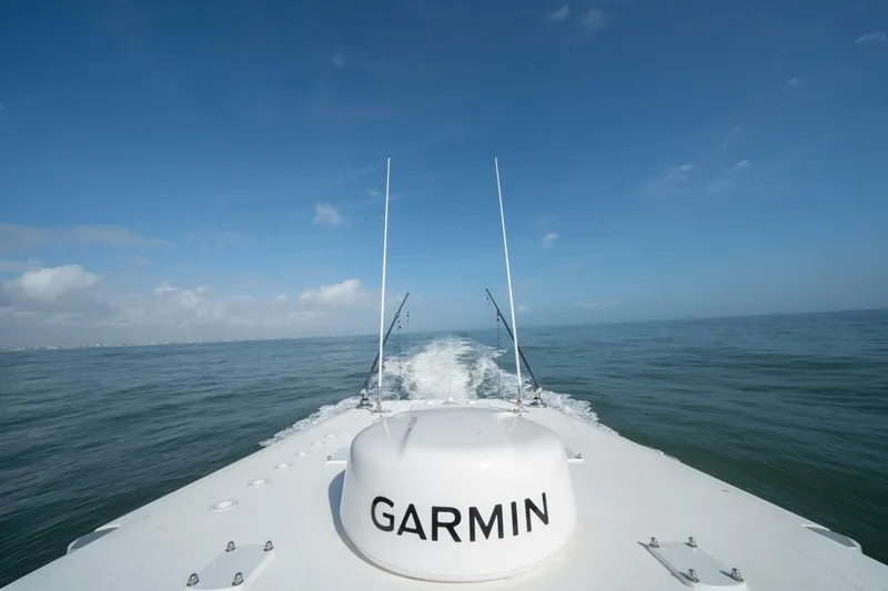 Kuhl Breeze Yacht Photos Pics 2024 Invincible 33 Catamaran cruising on open sea under clear blue sky.