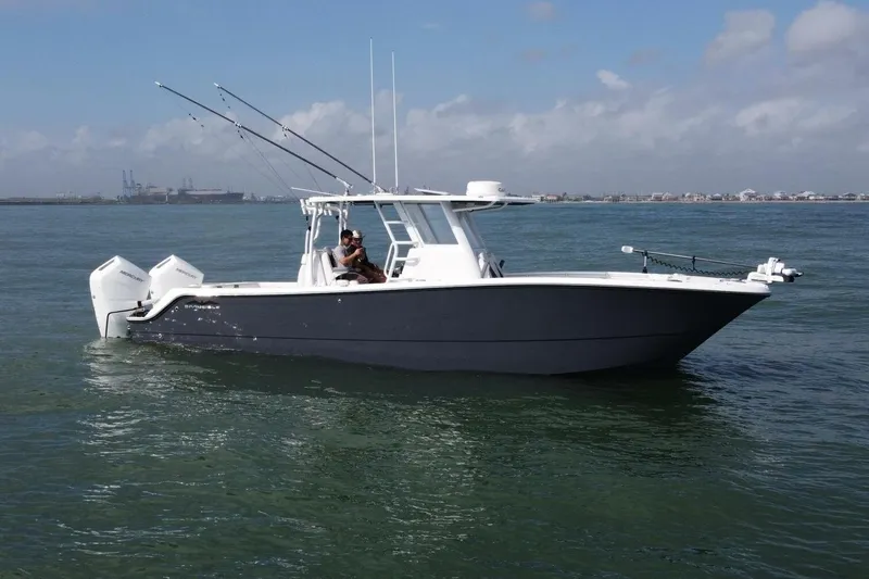 Kuhl Breeze Yacht Photos Pics 2024 Invincible 33 Catamaran cruising on calm waters under a clear sky.