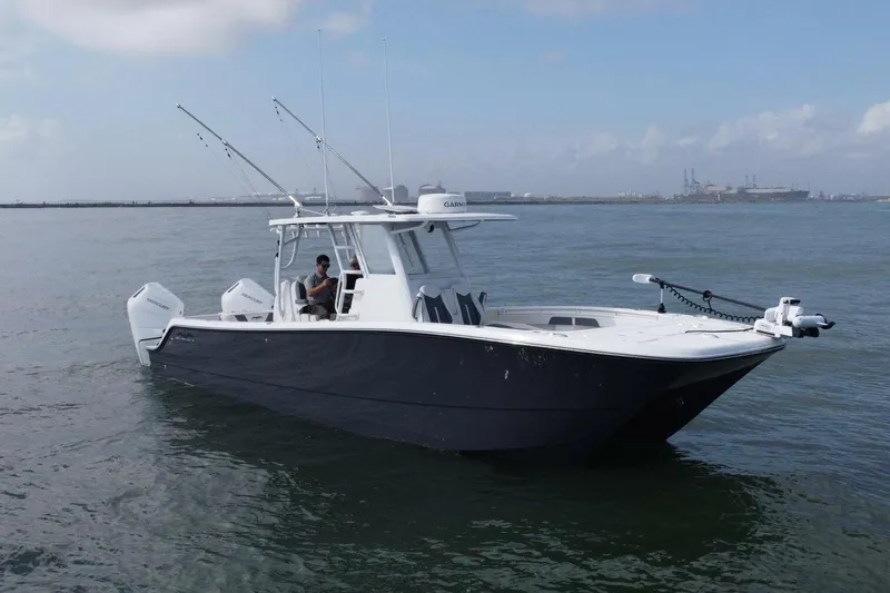 Kuhl Breeze Yacht Photos Pics 2024 Invincible 33 Catamaran on calm water, featuring sleek design and modern equipment.