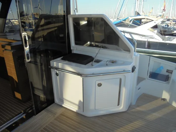  Yacht Photos Pics Outdoor kitchenette on 2012 Azimut 55S yacht, featuring grill and storage, docked at marina.