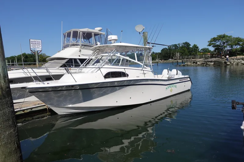  Yacht Photos Pics 2002 Grady White 300 Marlin boat docked at a marina on a sunny day.