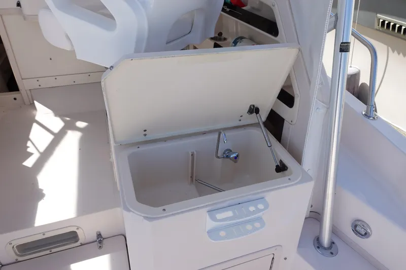  Yacht Photos Pics 2002 Grady White 300 Marlin boat interior with open storage compartment and faucet.