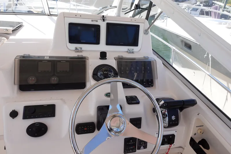  Yacht Photos Pics 2002 Grady White 300 Marlin boat helm with steering wheel and navigation controls.