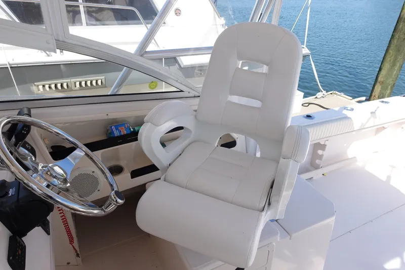  Yacht Photos Pics Captain's chair and steering wheel on a 2002 Grady White 300 Marlin boat.