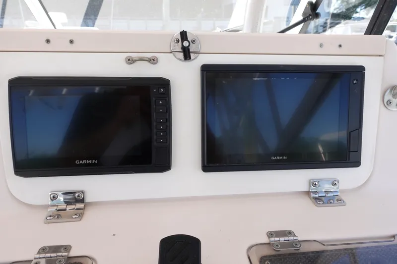  Yacht Photos Pics Garmin navigation screens on a 2002 Grady White 300 Marlin boat dashboard.
