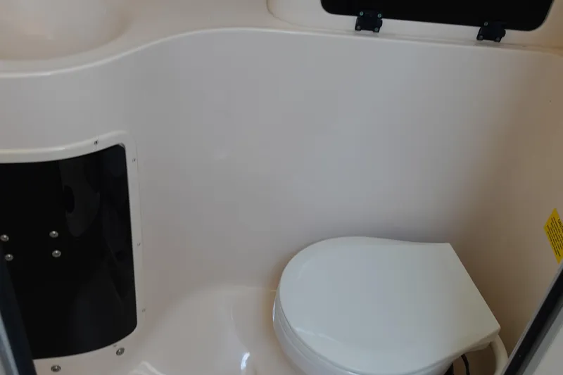  Yacht Photos Pics 2002 Grady White 300 Marlin boat interior with compact marine toilet.