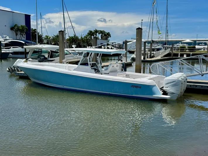  Yacht Photos Pics 2020 Intrepid 375 Nomad FE boat docked at a marina under a clear blue sky.