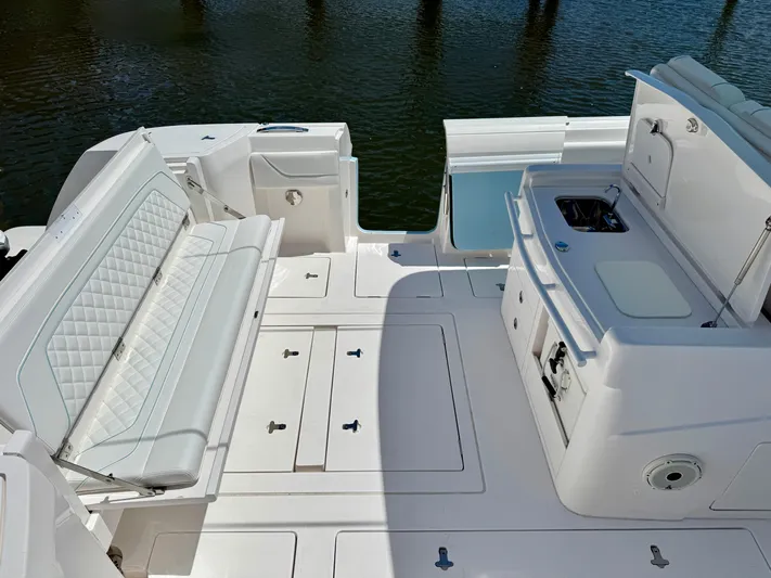  Yacht Photos Pics 2020 Intrepid 375 Nomad FE boat interior with seating and kitchenette.