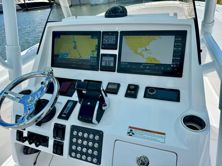 Yacht Photos Pics Control panel of a 2020 Intrepid 375 Nomad FE boat with navigation screens.