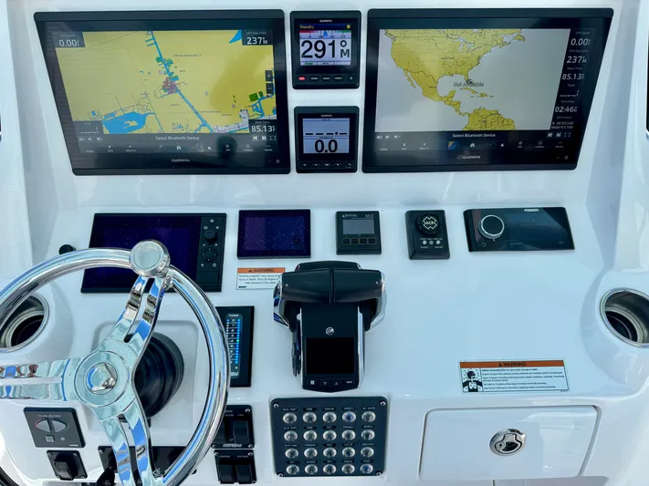  Yacht Photos Pics Control panel of 2020 Intrepid 375 Nomad FE with navigation screens and steering wheel.
