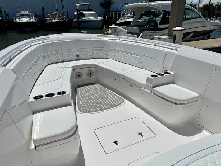 Yacht Photos Pics 2020 Intrepid 375 Nomad FE boat interior with white seating and cup holders.