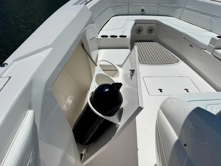  Yacht Photos Pics 2020 Intrepid 375 Nomad FE boat interior with storage compartment and seating area.