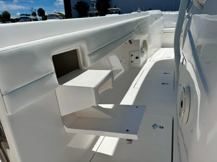  Yacht Photos Pics 2020 Intrepid 375 Nomad FE boat interior with white seating and storage compartments.