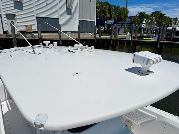  Yacht Photos Pics 2020 Intrepid 375 Nomad FE boat deck with radar, docked near buildings and palm trees.