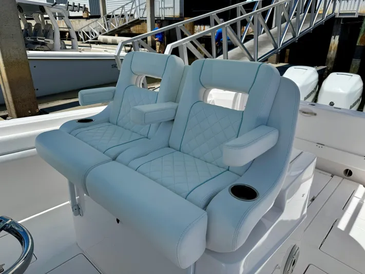  Yacht Photos Pics Luxurious seating on a 2020 Intrepid 375 Nomad FE boat, featuring quilted upholstery and armrests.