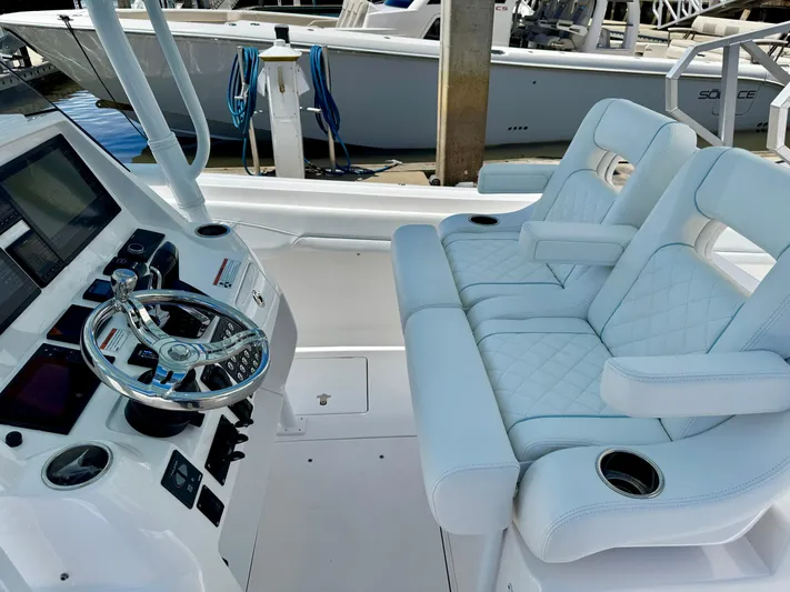 Yacht Photos Pics 2020 Intrepid 375 Nomad FE boat interior with luxurious seating and modern helm controls.