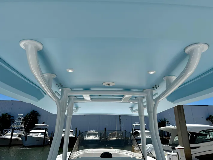  Yacht Photos Pics 2020 Intrepid 375 Nomad FE boat with blue T-top and docked yachts in background.