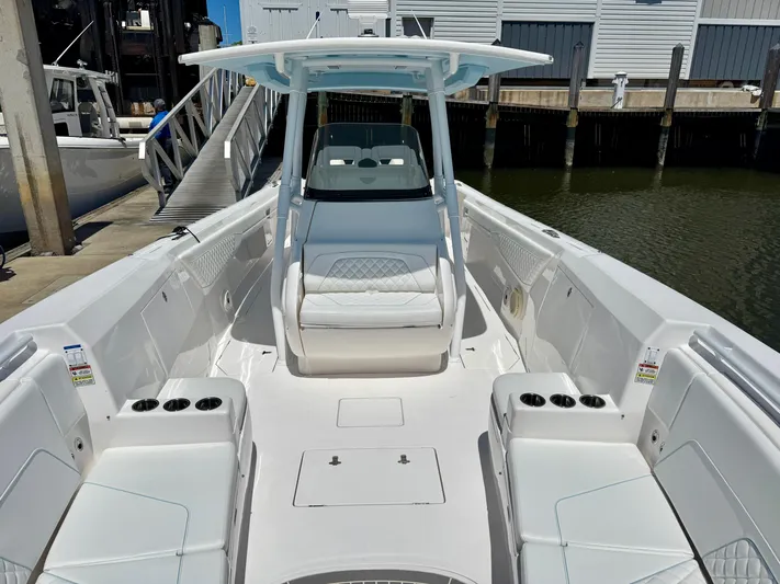  Yacht Photos Pics 2020 Intrepid 375 Nomad FE boat with spacious seating and sleek design at a marina.