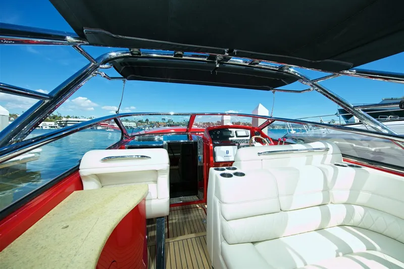  Yacht Photos Pics Interior of a 2002 Hallett Express Cruiser with white seating and modern dashboard.