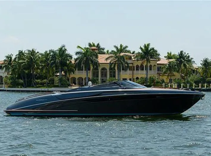  Yacht Photos Pics 2014 Riva Rivarama Super 44 yacht cruising near luxury waterfront mansion.