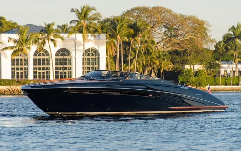  Yacht Photos Pics 2014 Riva Rivarama Super 44 yacht cruising near elegant waterfront estate.