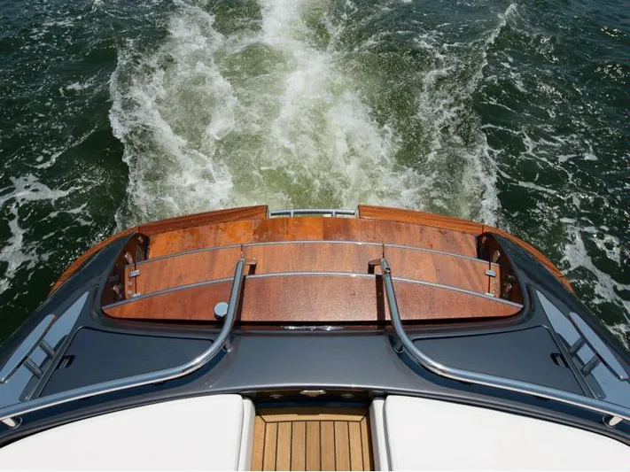  Yacht Photos Pics 2014 Riva Rivarama Super 44 yacht cruising on water, showcasing elegant wooden deck.